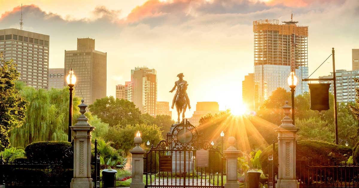 Paul Revere in front of Boston skyline at sunrise