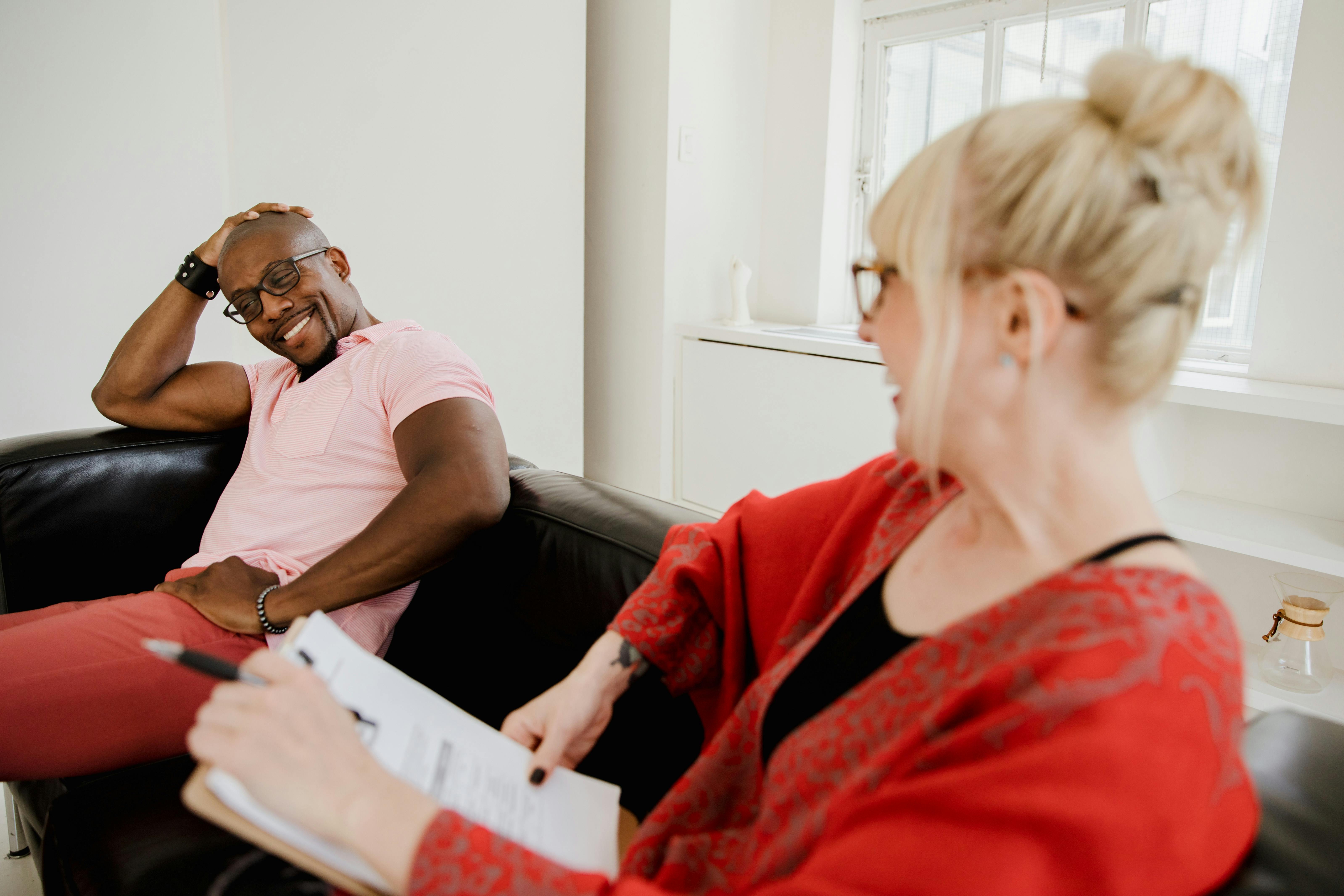A cognitive-behavioral therapy session with a client and his therapist.