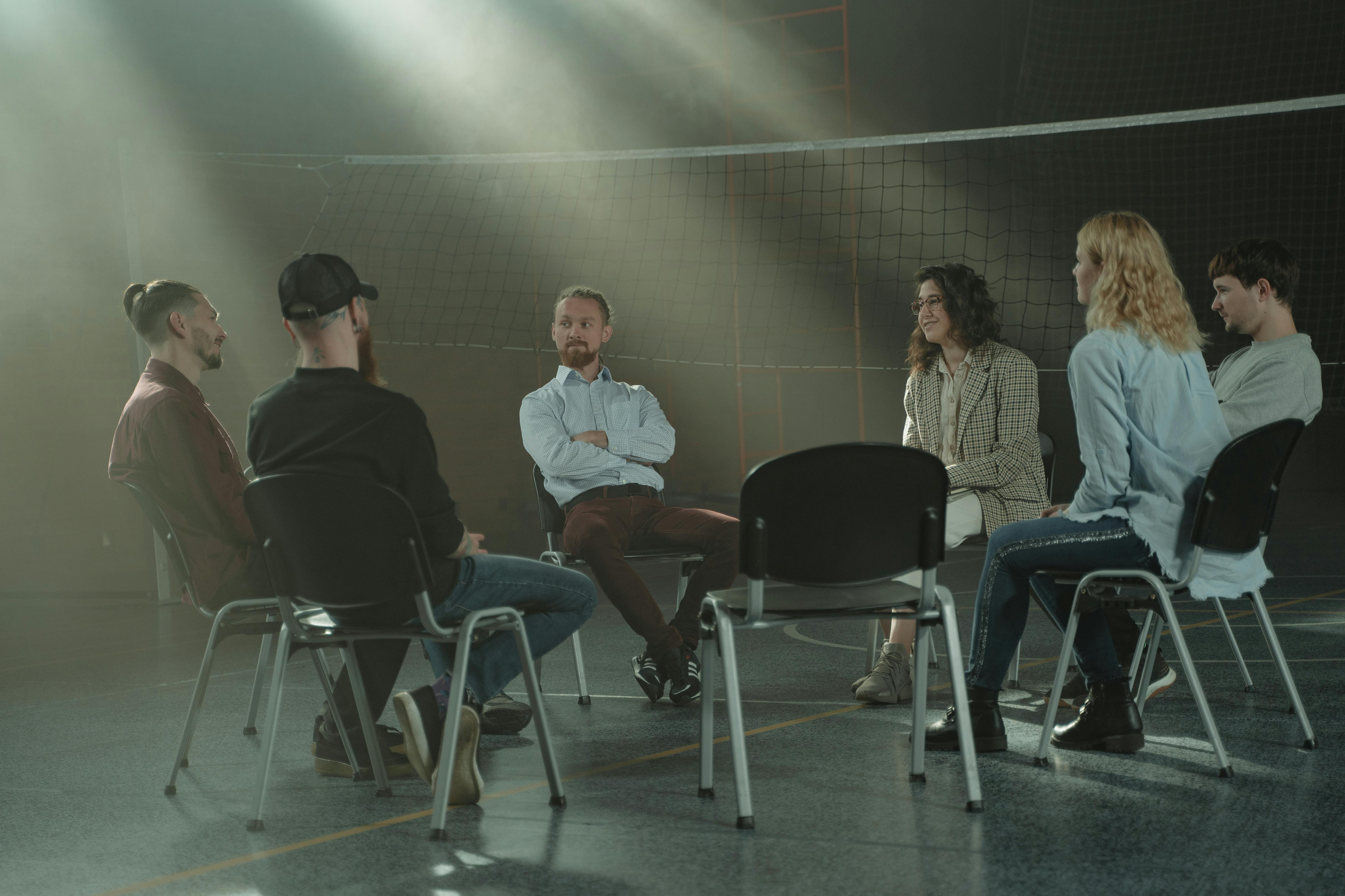 Six people gathered for a group therapy session.