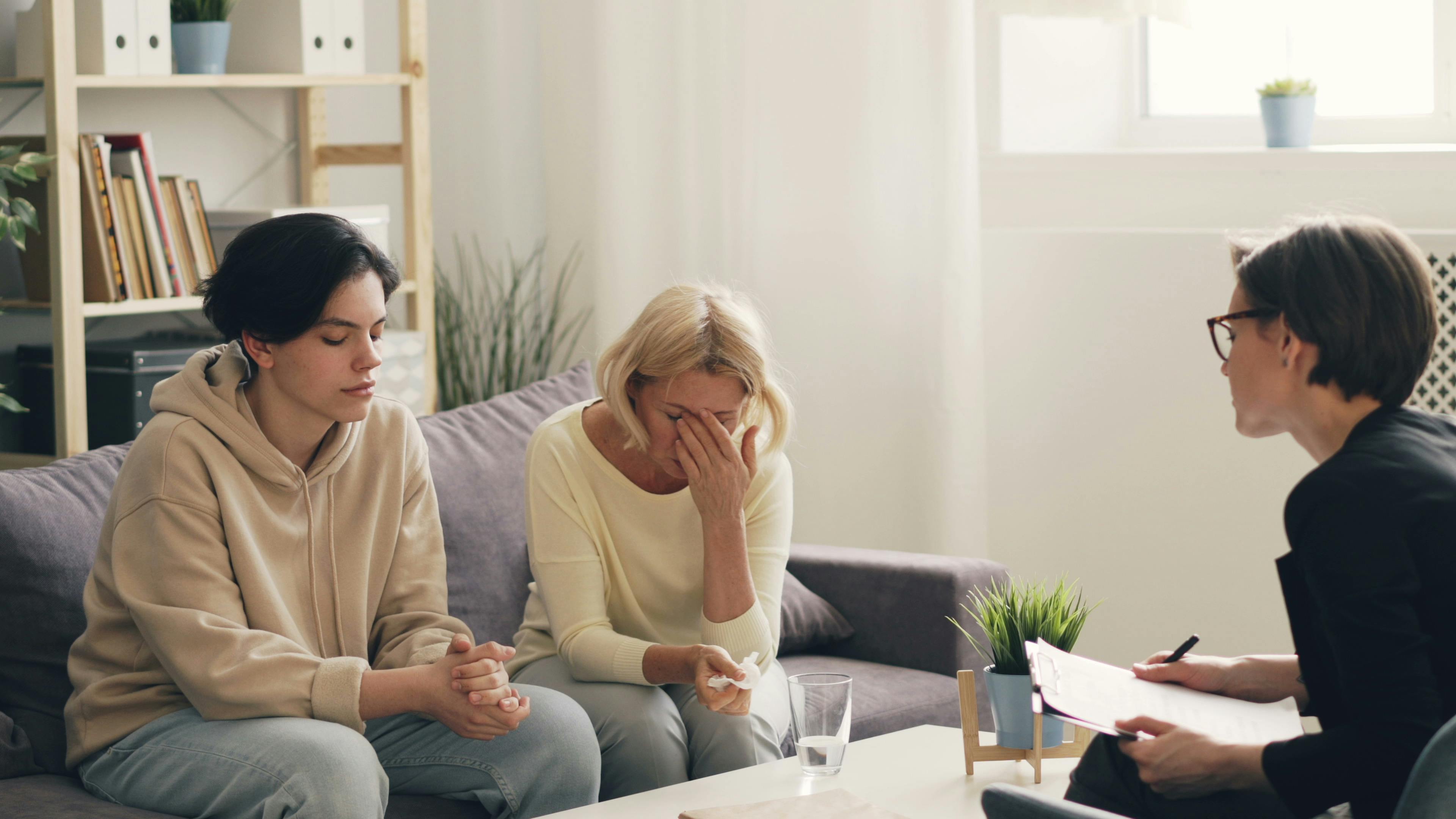 A group therapy session with two people and their therapist.