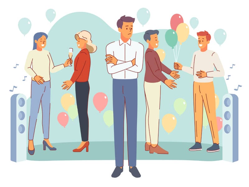A man at a party experiencing social anxiety or introversion.